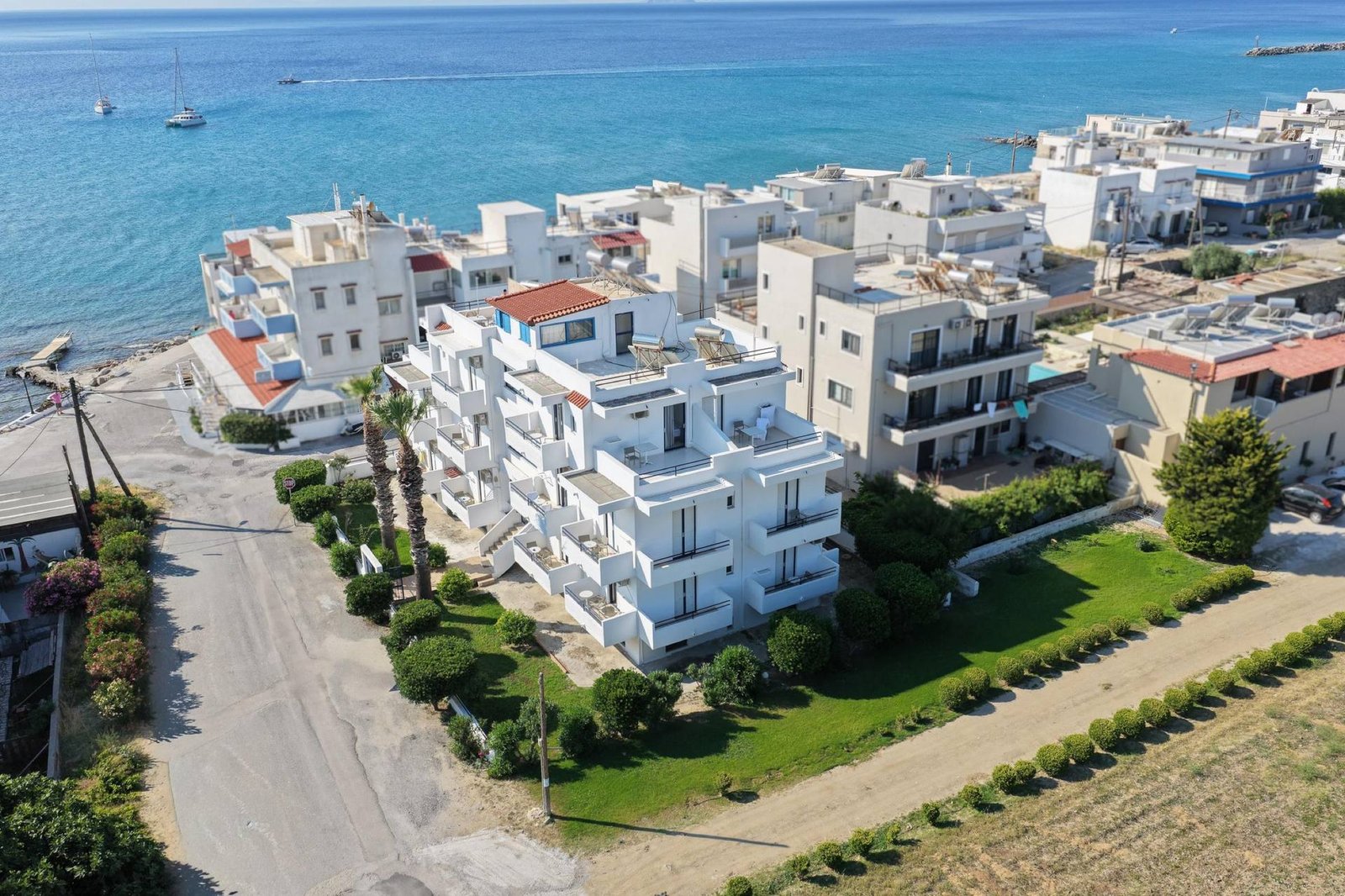Philippos Studios & Apartments seen from above, with the Aegean Sea behind